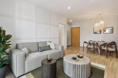 a white kitchen with a sink and a table at Sabia - 2 bedrooms in Poblenou in Barcelona