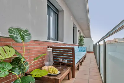 a patio with a couch and a table on a building at Modern Penthouse with Large Terrace in Poblenou Perfect for Holidays or Work Close to the Beach and Public Transport in Barcelona