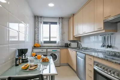 a kitchen with a table with fruit on it at Modern Penthouse with Large Terrace in Poblenou Perfect for Holidays or Work Close to the Beach and Public Transport in Barcelona