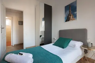 a bedroom with a bed with a dog laying on it at Cozy and Modern Apartment in Poblenou 3 Bedrooms Perfect for 4 Guests in Barcelona