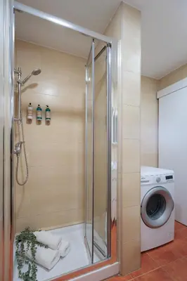 a shower stall with a washing machine in a bathroom at Cozy and Modern Apartment in Poblenou 3 Bedrooms Perfect for 4 Guests in Barcelona
