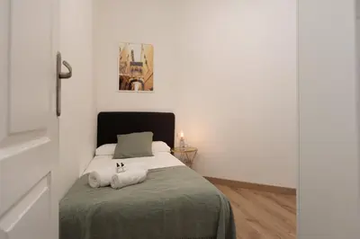 a bedroom with a bed with two towels on it at Cozy and Modern Apartment in Poblenou 3 Bedrooms Perfect for 4 Guests in Barcelona