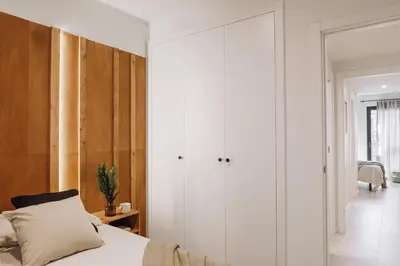 a bedroom with white cabinets and a bed at Dabo - 3 bedrooms in Eixample Esquerra in Barcelona