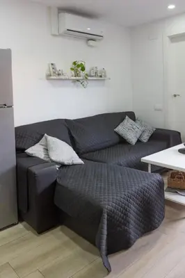 a living room with a couch and a table at Terrace & BEACH apartment in Calella