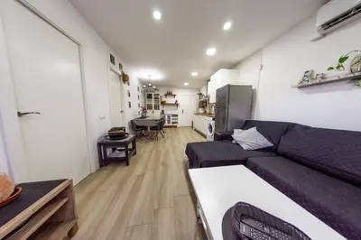 a living room with a couch and a kitchen at Terrace & BEACH apartment in Calella