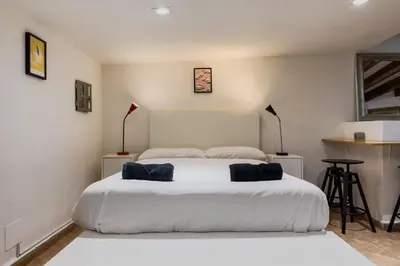a bedroom with a large white bed with two pillows at Casa en Barcelona in Barcelona