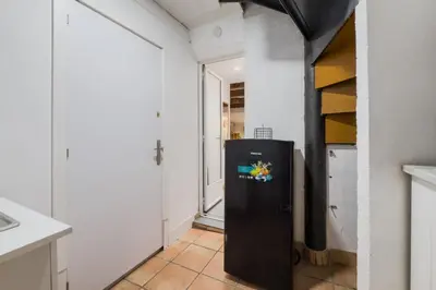 a black refrigerator in a kitchen with a hallway at Casa en Barcelona in Barcelona