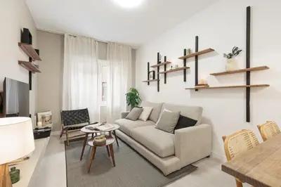 a living room with a couch and a table at Lourdes - 3 bedrooms apartment in Sant Gervasi in Barcelona