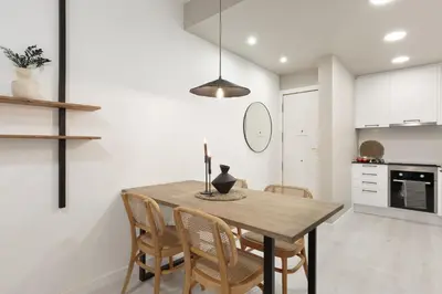 a kitchen and dining room with a wooden table and chairs at Lourdes - 3 bedrooms apartment in Sant Gervasi in Barcelona