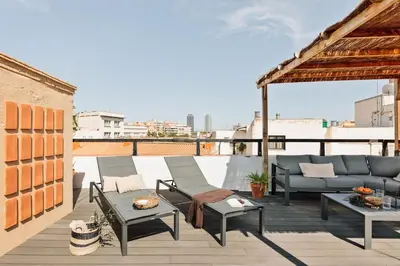 a patio with chairs and tables on a roof at Atuh - Studio and terrace in El Born in Barcelona