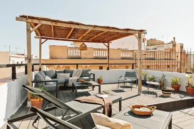 a table with a bowl of food and two glasses of wine at Atuh - Studio and terrace in El Born in Barcelona