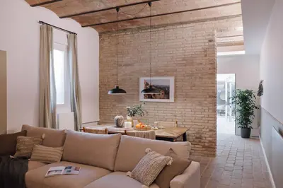 a bedroom with a bed and two lamps and a brick wall at Ejido - 1 bedroom and terrace in Gràcia in Barcelona
