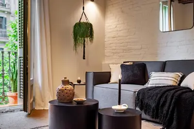 a living room with a tv and a couch at Baharya - 2 bedrooms in Eixample Dreta in Barcelona