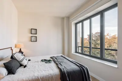 a bedroom with a large bed with two lamps at Garraf - 2 bedrooms and balcony in Sant Gervasi in Barcelona