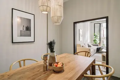a bedroom with a bed and a table in it at Albori - 2 bedrooms and balcony in Eixample Dreta in Barcelona