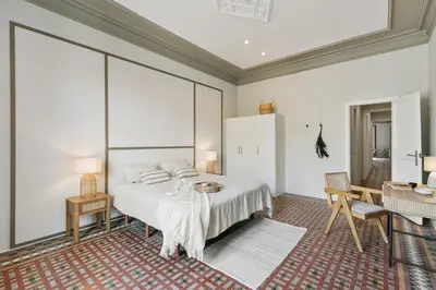 a white bedroom with a bed and a large window at Albori - 2 bedrooms and balcony in Eixample Dreta in Barcelona
