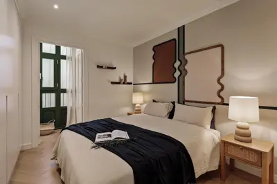 a large kitchen with black cabinets and a sink at Fener - 3 bedrooms in La Dreta de l'Eixample in Barcelona