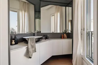 a bathroom with a black and white sink and a bedroom at Fener - 3 bedrooms in La Dreta de l'Eixample in Barcelona
