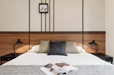 a bedroom with a bed and a table with a lamp at Falco - 2 bedrooms with shared pool in Les Corts in Barcelona