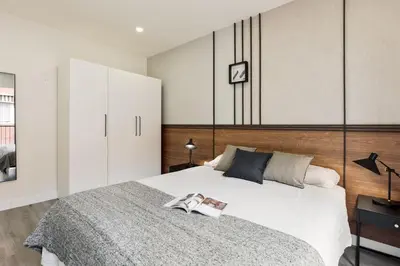 a bedroom with a bed with a book on it at Falco - 2 bedrooms with shared pool in Les Corts in Barcelona