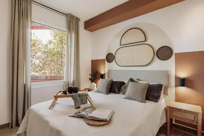 a living room with a couch and a table at Gumus - 3 bedrooms and office in Les Tres Torres in Barcelona