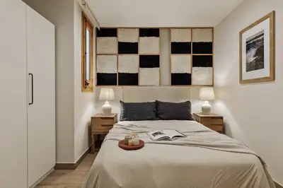 a kitchen with white cabinets and a wooden counter top at Amatitlan - 3 bedrooms and balcony in Eixample in Barcelona