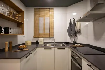 a bedroom with a dresser and a chair next to a window at Yoko - 3 bedrooms and terrace in Eixample Dreta in Barcelona