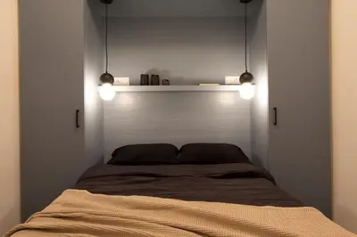 a small bedroom with a bed and a window at Yoko - 3 bedrooms and terrace in Eixample Dreta in Barcelona