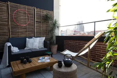 a living room with a couch and a table at Yoko - 3 bedrooms and terrace in Eixample Dreta in Barcelona