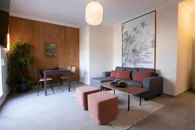 a living room with a couch and a table on a balcony at Yoko - 3 bedrooms and terrace in Eixample Dreta in Barcelona