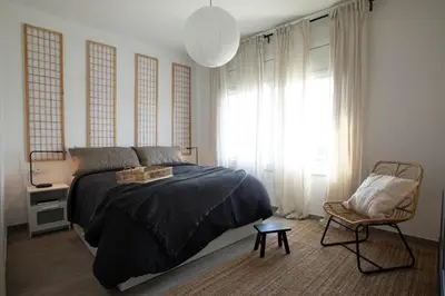 a living room with a couch and a chair at Yoko - 3 bedrooms and terrace in Eixample Dreta in Barcelona