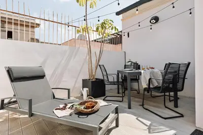 a patio with chairs and a table on a balcony at Aoraki - Penthouse and terraces in Eixample Dreta in Barcelona