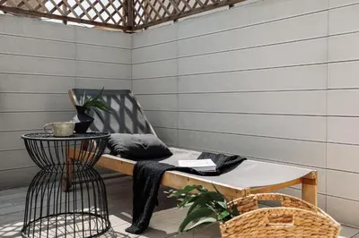 a chair and a table on a patio at Aoraki - Penthouse and terraces in Eixample Dreta in Barcelona