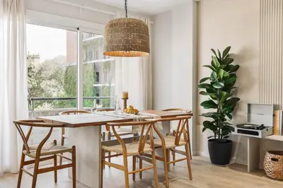 a kitchen with white cabinets and a table and chairs at Arienzo - 2 bedrooms and balcony in Sant Gervasi in Barcelona