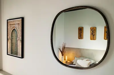 a bedroom with a large bed and a mirror at Asrir - 2 bedroom, terrace and pool in Poblenou in Barcelona