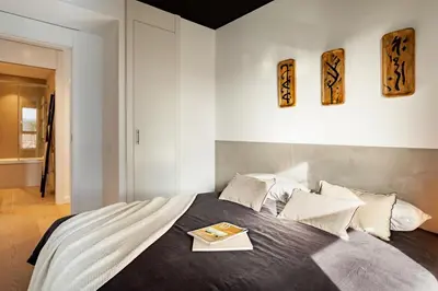 a round mirror hanging on a wall with a room at Asrir - 2 bedroom, terrace and pool in Poblenou in Barcelona