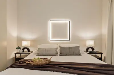 a white living room with a couch and a desk at Wabi - 2 bedrooms and terrace in Passeig de Gràcia in Barcelona