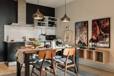 a kitchen and living room with a table and chairs at Wabi - 2 bedrooms and terrace in Passeig de Gràcia in Barcelona