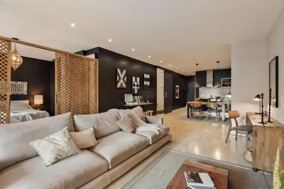a living room with a couch and a table at Wabi - 2 bedrooms and terrace in Passeig de Gràcia in Barcelona