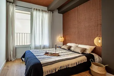 a kitchen with white cabinets and a dining room at Chalby - 4 bedrooms in Eixample Esquerra in Barcelona