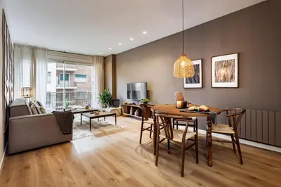 a living room with a dining room table and a couch at Isilf - 2 bedrooms and balcony in Sant Gervasi in Barcelona