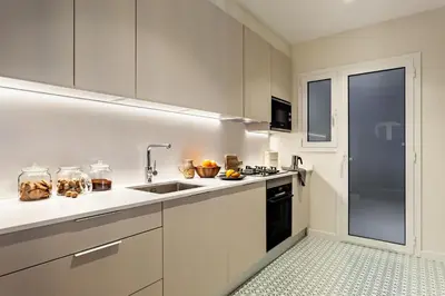 a kitchen with white cabinets and a sink at Isilf - 2 bedrooms and balcony in Sant Gervasi in Barcelona