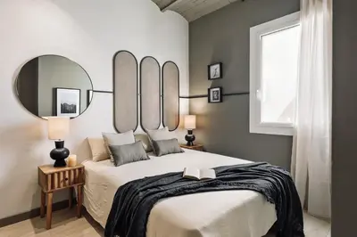 a bedroom with a large bed with mirrors on the wall at Pirineu - 2 bedrooms in Sant Gervasi in Barcelona