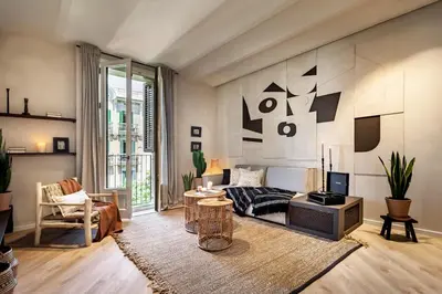 a living room with a couch and a tv at Nubian - 2 bedrooms in Eixample Dreta in Barcelona