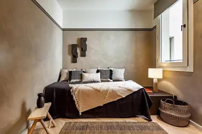 a bedroom with a bed and a brick wall at Nubian - 2 bedrooms in Eixample Dreta in Barcelona