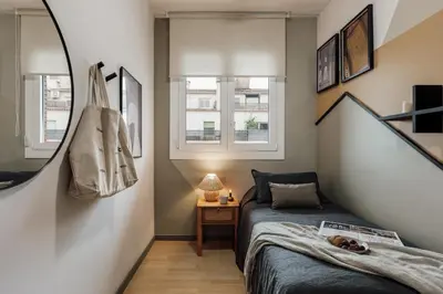 a living room with a table and a mirror at Basil - 3 bedrooms and terrace in Sant Gervasi in Barcelona