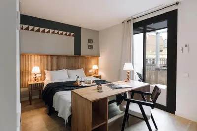 a living room with a table and chairs and a couch at Sultan - 2 bedrooms and terrace in Eixample Dreta in Barcelona