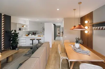 a dining room and living room with a table and chairs at Sultan - 2 bedrooms and terrace in Eixample Dreta in Barcelona