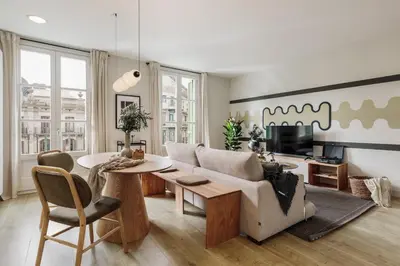a living room with a couch and a table at Mescit - 2 bedrooms and balcony in Eixample Dreta in Barcelona