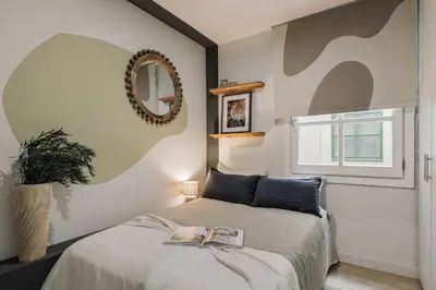 a bedroom with a bed with a book on it at Mescit - 2 bedrooms and balcony in Eixample Dreta in Barcelona